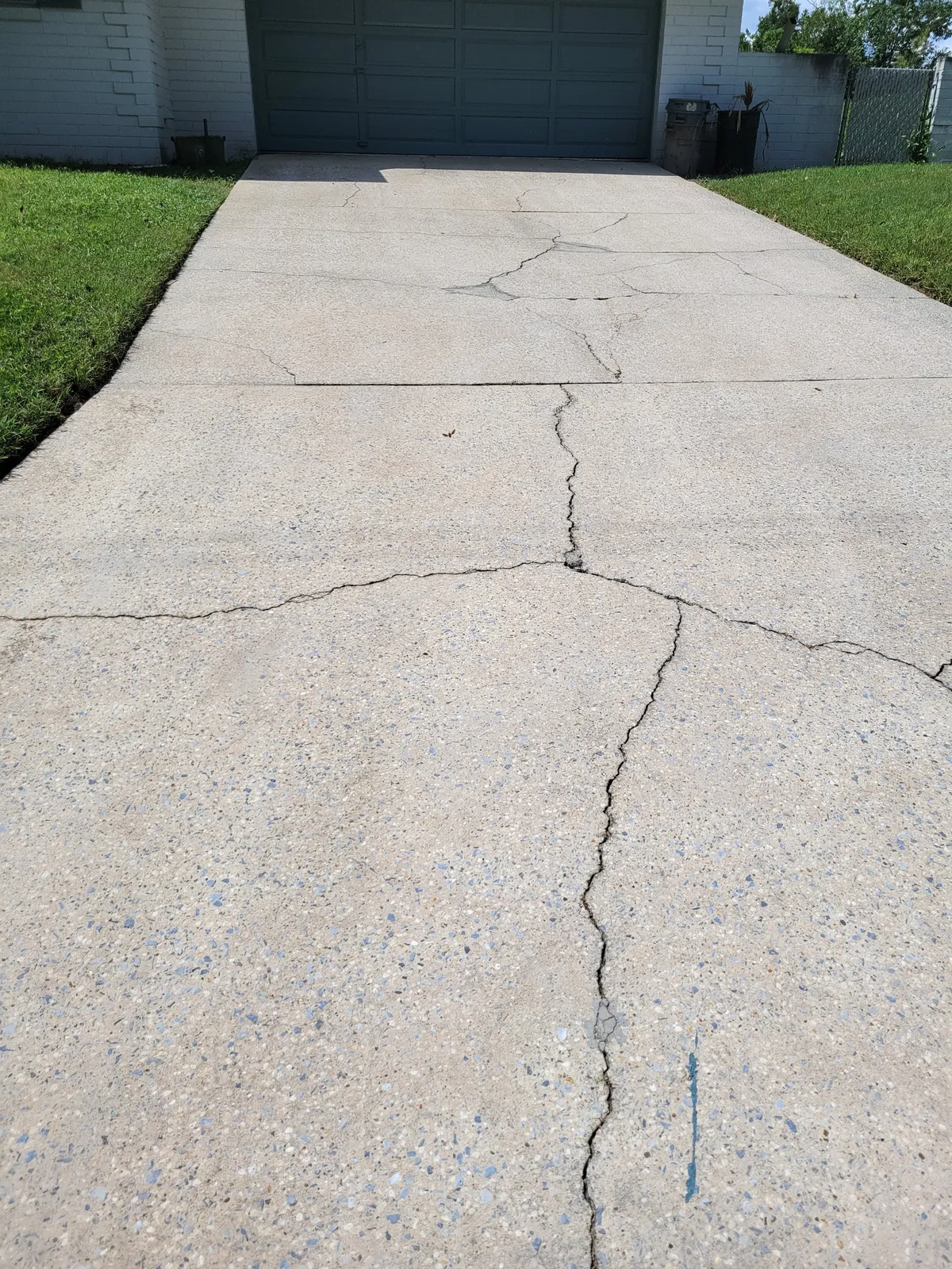 After: Three years of ground-in dirt and tire marks stripped off a two-car driveway.