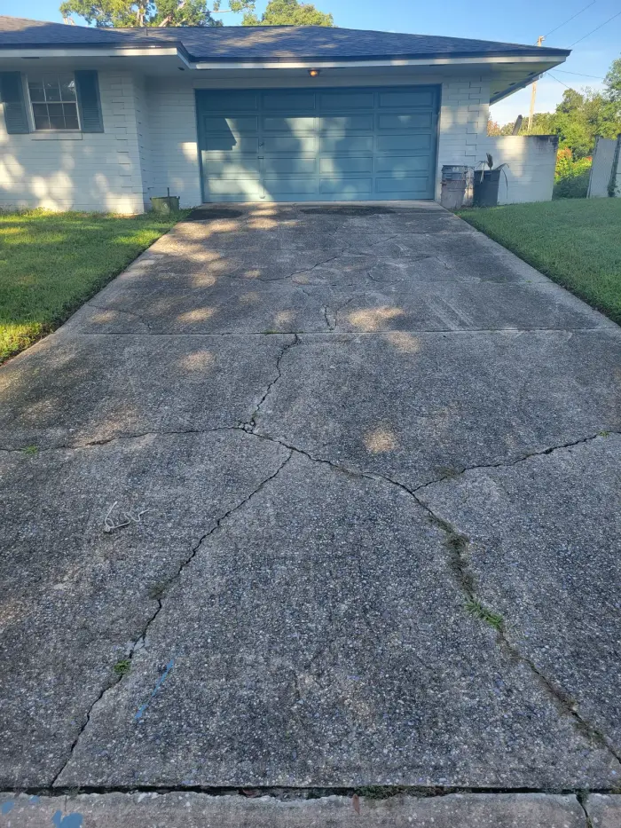 Before: Three years of ground-in dirt and tire marks stripped off a two-car driveway.